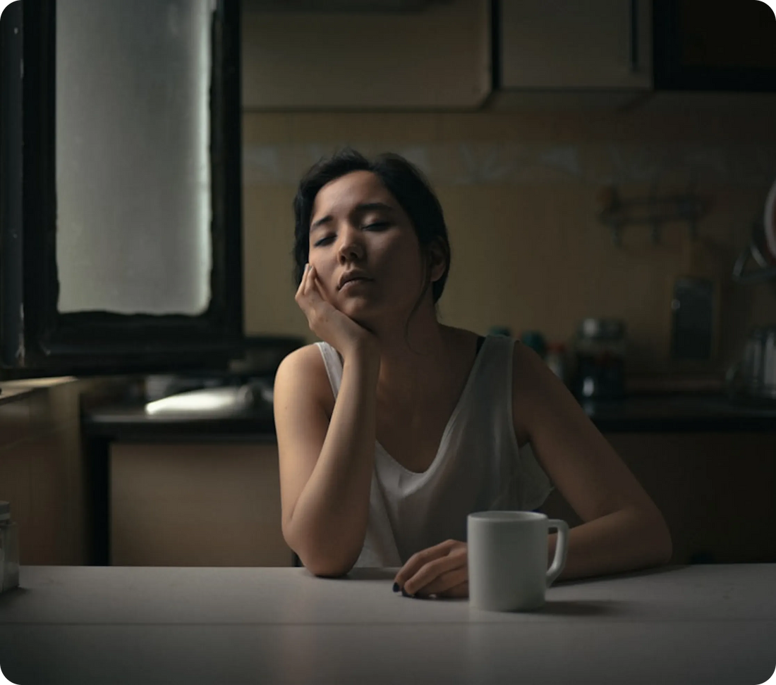 Tired mom sitting at a kitchen table